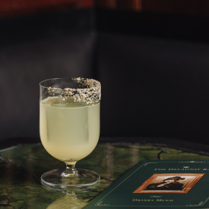 An Art Nouveau-inspired cocktail from The Delaunay, featuring elegant glassware, floral garnishes, and intricate Viennese-style details