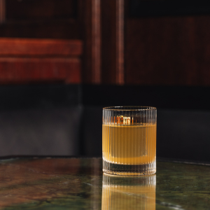 An Art Nouveau-inspired cocktail from The Delaunay, featuring elegant glassware, floral garnishes, and intricate Viennese-style details